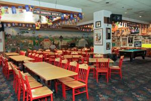 a restaurant with tables and chairs and a pool table at Bavarian Inn Lodge in Frankenmuth
