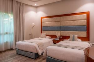 Postel nebo postele na pokoji v ubytování فندق لاجونا ڤيستا بريدة