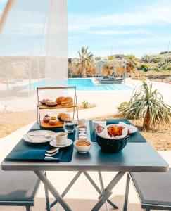 a picnic table with a tray of food on it at Etherea - I Dammusini di Pantelleria in Pantelleria