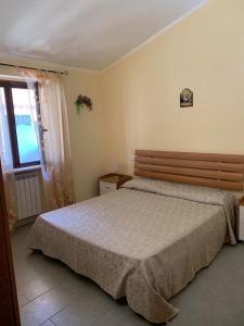 a bedroom with a bed and a window at Appartamenti Santa Domenica in Santa Domenica