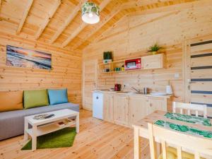 a living room with a couch and a table in a cabin at Domki Letniskowe Słoneczna Przystań in Ustka