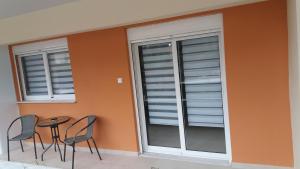 - une terrasse avec 2 fenêtres, une table et des chaises dans l'établissement serres@home, à Serres