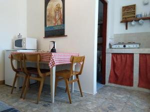 a kitchen with a table with two chairs and a stove at Seaside Villa Katrine in Banjol