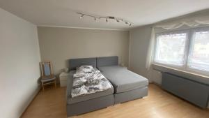 a small bedroom with a bed and a window at Ferienwohnung Mittel-Gründau in Gründau