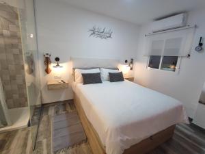 a bedroom with a large bed and a glass shower at Torremolinos Suite in Torremolinos