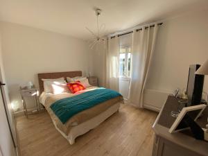 a bedroom with a bed with a green blanket at Villa d Agathe en Provence Graveson in Graveson