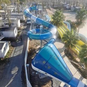 a blue water slide at a water park at mobilhome 500m mer camping LA CARABASSE in Vias