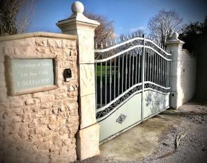 a white gate with a sign in front of it at Domaine "Les Bois Flottes" dans Maison de Charme au bord de mer et proche de Cabourg in Merville-Franceville-Plage