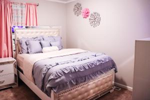 um quarto com uma cama com almofadas roxas em Luxury 3b,2bts Loft Apt of a House Near shops em Lithonia
