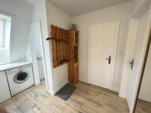 a laundry room with a washing machine and a door at Ferienwohnung Hering in Büsum +7 photos