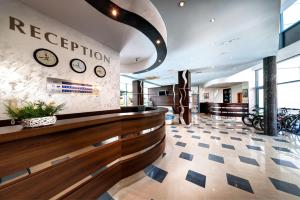 a lobby of a hotel with clocks on the wall at Blue Bay Hotel in Sunny Beach +85 photos