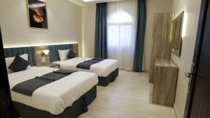 En eller flere senge i et værelse på المنار للوحدات الفندقية