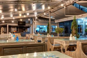 a restaurant with tables and chairs and lights at Blue Bay Hotel in Sunny Beach
