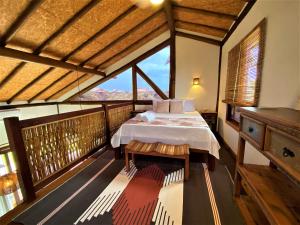 a bedroom with a bed and a large window at Taipu Loft - Península de Maraú in Marau