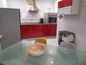 a kitchen with red cabinets and a bowl on a counter at Ferienwohnung Haiber - Remseck in Remseck am Neckar
