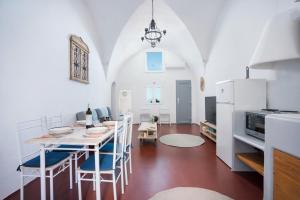 a kitchen and dining room with a table and chairs at Kastro Cave House in Pirgos