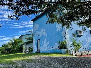 a blue building with a mural on it at Color Rainbow Home in Taimali