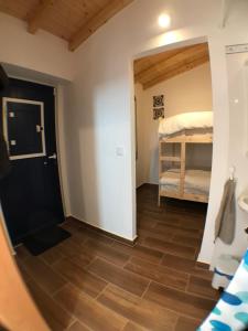 a view of a room with a bedroom and a bunk bed at Quarto Santo António in Zambujeira do Mar