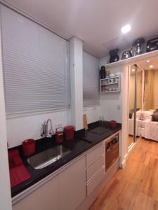 a kitchen with a sink and a counter top at Vem pro Arouche/República -Studio- 4 min do Metrô in Sao Paulo +10 photos