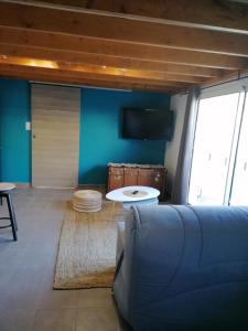 a living room with a couch and a table at Chambre familiale "le pêcher" in Saillans