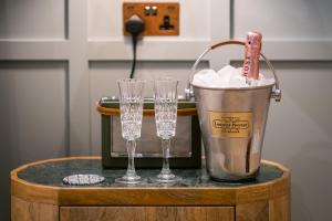 due bicchieri di vino e un secchio sul tavolo di The White House a Bowness-on-Windermere