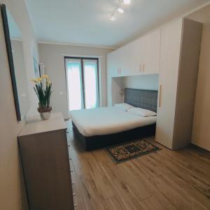 sypialnia z łóżkiem w pokoju z drewnianą podłogą w obiekcie CASA VACANZE DA GABRI w mieście Tirano