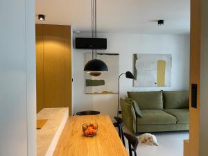 a living room with a table and a couch at Turbo Apartament pod Szyndzielnią i Dębowcem in Bielsko-Biala +6 photos