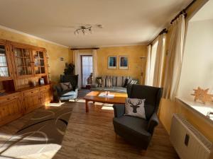 a living room with a couch and a table at Ferienwohnungen Kral in Grainau