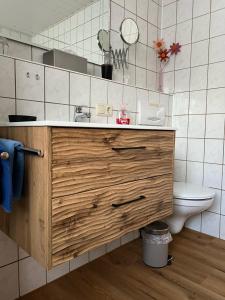 a bathroom with a sink and a toilet at Ferienwohnungen Kral in Grainau +34 photos