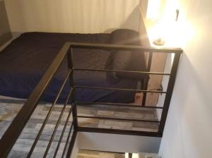 a bedroom with a bunk bed and a stairway to a bunk bed at Séjour en amoureux avec jacuzzi et sauna in Balbigny