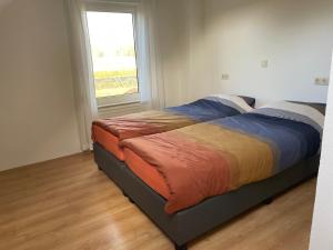Ένα ή περισσότερα κρεβάτια σε δωμάτιο στο Vakantiewoning Op De Bos