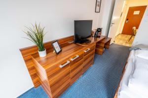 Televízia a/alebo spoločenská miestnosť v ubytovaní WELLNESS HOTEL FRYMBURK APARTMAN 502C