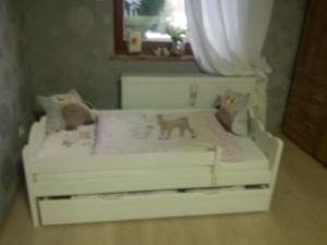 a white crib with a cat toy on it at Haus Bergrose in Busenborn