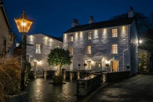 un edificio illuminato con un lampione di The White House a Bowness-on-Windermere