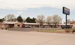 a gas station with a sign in front of it at Budget Inn & Suites Colby in Colby