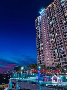 um edifício alto com luzes à frente à noite em Havona Residence By JettBros Johor Bahru em Johor Bahru