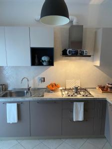 A kitchen or kitchenette at AGM Suite Rome Airport FCO - Attico Parco Leonardo Még 37 kép