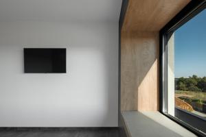 Televízia a/alebo spoločenská miestnosť v ubytovaní Villa Merapi