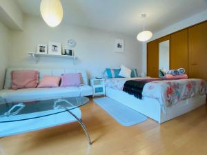 a living room with two beds and a couch at SUNY 402 in Tokyo