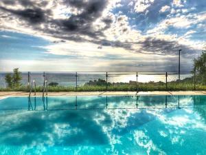 a swimming pool with a view of the ocean at Villa Santa Barbara in Cefalù