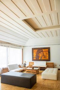 a living room with a coffered ceiling and a couch at The Eco Palace Hostel in Búzios +61 photos