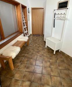 a living room with a tiled floor with a ladder at Appart sympa ! in Sonceboz