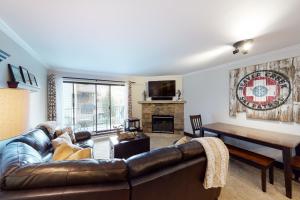 a living room with a leather couch and a table at Beaver Creek West G3 in Beaver Creek