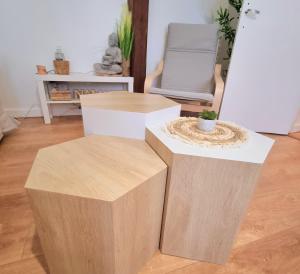 two wooden stools in a room with a chair at "Bambou Zen" - 5 couchages - Vieux Tours in Tours