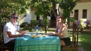 a man and a woman sitting at a table at The ED Corner - Hiriketiya in Dickwella