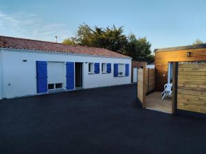 a house with a garage with a driveway at La Petite Maison Des Marais in Bourgneuf-en-Retz