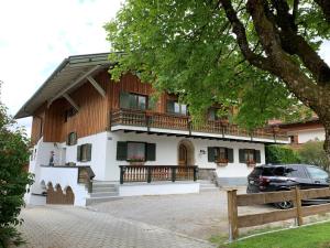 a house with a car parked in front of it at Apartment Ape Maja in Bad Wiessee