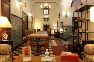 a living room filled with furniture and tables at Riad Meftaha in Rabat