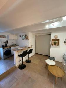 a kitchen with a table and chairs and a chalkboard at Studio vallon d'Azur à Carqueiranne in Carqueiranne