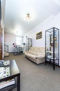 a living room with a bed and a table at Mini Hotel on Saydasheva in Kazan